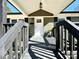 Charming front porch with stained wood railings, a hanging pendant light, and new exterior paint at 4513 Munsee St, Charlotte, NC 28213