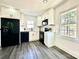 Kitchen with white cabinetry, black appliances, and updated fixtures at 4513 Munsee St, Charlotte, NC 28213
