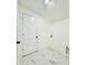 Bright laundry room with whitewashed walls and marble-look flooring at 4513 Munsee St, Charlotte, NC 28213