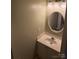 Small half bathroom with round mirror and vanity at 484 Lexie Ln, Rock Hill, SC 29732