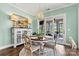 Charming dining area with round table and chairs, and access to backyard patio at 4998 Looking Glass Trl, Denver, NC 28037