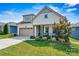 Two-story home with light-colored siding and a charming porch at 4998 Looking Glass Trl # 461, Denver, NC 28037