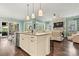 Open concept kitchen with large island, stainless steel appliances, and view into living room at 4998 Looking Glass Trl, Denver, NC 28037