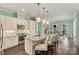 Modern kitchen with white cabinets, granite island, and stainless steel appliances at 4998 Looking Glass Trl, Denver, NC 28037