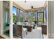Relaxing screened porch with wicker furniture and blue and white accents at 4998 Looking Glass Trl, Denver, NC 28037