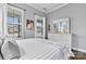 Bright bedroom with hardwood floors, large windows, and a stylish dresser with a mirror at 4998 Looking Glass Trl, Denver, NC 28037