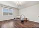 Bright bonus room featuring hardwood floors, a large window and fitness equipment at 4998 Looking Glass Trl, Denver, NC 28037