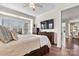 Comfortable main bedroom with hardwood floors, ceiling fan, and large window for ample natural light at 4998 Looking Glass Trl, Denver, NC 28037