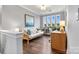 Bright office space with hardwood floors, plenty of natural light, and a comfortable work area at 4998 Looking Glass Trl, Denver, NC 28037