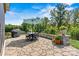Relaxing stone patio with seating area, umbrella, and grill at 4998 Looking Glass Trl, Denver, NC 28037