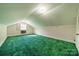 This attic space offers potential with its sloped ceilings, window, and unique carpeting at 531 Elm St, Salisbury, NC 28144