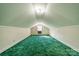 Expansive attic with green carpet and white wallpaper providing ample storage or potential for a unique living space at 531 Elm St, Salisbury, NC 28144