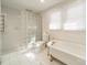 Bright bathroom with a glass block shower, freestanding tub, and tile flooring offering a luxurious retreat at 531 Elm St, Salisbury, NC 28144