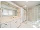 Bright bathroom with double vanity, tile floors, and a glass block shower providing a spa-like experience at 531 Elm St, Salisbury, NC 28144