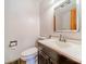 Clean bathroom featuring a sink, toilet, and mirror with traditional white tiles at 531 Elm St, Salisbury, NC 28144
