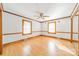 Bedroom featuring hardwood floors, classic trim, and ample natural light streaming through large windows at 531 Elm St, Salisbury, NC 28144