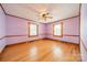 Spacious bedroom with hardwood floors, classic trim, two windows, and a ceiling fan at 531 Elm St, Salisbury, NC 28144
