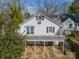 A rear view of a home with a deck, providing outdoor space and backyard access via a spiral staircase at 531 Elm St, Salisbury, NC 28144