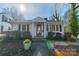 Charming home with classic columns, black shutters, and colorful flowerpots at 531 Elm St, Salisbury, NC 28144