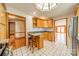 Bright kitchen featuring wooden cabinets, granite countertops, and white tile floors at 531 Elm St, Salisbury, NC 28144