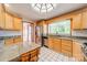 Kitchen features a skylight, granite countertops, wooden cabinets, and stainless steel appliances at 531 Elm St, Salisbury, NC 28144