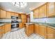 Kitchen boasts stainless steel appliances, granite countertops, and wooden cabinets and shelving at 531 Elm St, Salisbury, NC 28144