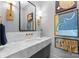 Modern bathroom with marble vanity, frameless mirror, and stylish light fixtures at 547 Cherokee Rd, Charlotte, NC 28207