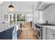 Bright kitchen features a farmhouse sink, stainless steel appliances, and hardwood floors at 547 Cherokee Rd, Charlotte, NC 28207