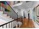 Elegant staircase with black metal railing and hardwood floors at 547 Cherokee Rd, Charlotte, NC 28207