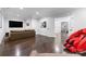 Finished basement with a sectional sofa, red massage chair, and hardwood floors at 5527 Carmel Park Dr, Charlotte, NC 28226