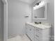 Modern bathroom with white vanity, marble countertop, and framed mirror at 5527 Carmel Park Dr, Charlotte, NC 28226