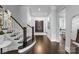 Grand staircase with dark wood and white railings at 5527 Carmel Park Dr, Charlotte, NC 28226