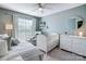 Bedroom with crib, dresser, area rug, and window with neutral curtains at 5806 Glassport Ln, Charlotte, NC 28210