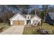 Tan two-car garage and charming front yard at 630 Montgomery Dr, Rock Hill, SC 29732