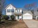 Two-story house with green shutters and a two-car garage at 7031 Lowen Rd, Charlotte, NC 28269