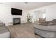 Living room with fireplace and hardwood floors, open to dining area at 7031 Lowen Rd, Charlotte, NC 28269