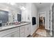 Double vanity bathroom with grey countertops and walk-in closet at 7853 Ballentrae Pl, Stanley, NC 28164