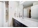 Bright bathroom vanity area with a large mirror and adjacent shower and toilet space at 109 Belfry Loop, Mooresville, NC 28117