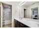 Bathroom featuring a dark vanity, sink, large mirror, and access to the shower and toilet at 109 Belfry Loop, Mooresville, NC 28117