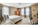 Bedroom with neutral decor, natural lighting, and space for work and relaxation at 109 Belfry Loop, Mooresville, NC 28117