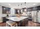 Modern kitchen with a large island, pendant lighting, stainless steel appliances, and dark cabinetry at 109 Belfry Loop, Mooresville, NC 28117