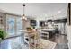 Stylish kitchen with dark cabinetry, stainless steel appliances, and an eat-in island at 109 Belfry Loop, Mooresville, NC 28117