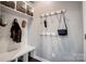 Organized mudroom with hooks, shelves, and bench, perfect for storage and convenience at 109 Belfry Loop, Mooresville, NC 28117