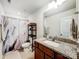 Bathroom featuring granite vanity, shower with marble curtains and a shelving unit at 1108 Township Pkwy, Belmont, NC 28012