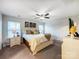 Bedroom with a ceiling fan, cozy bedding, and natural light from the windows at 1108 Township Pkwy, Belmont, NC 28012