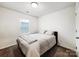 Well-lit bedroom with neutral tones and large window at 1108 Township Pkwy, Belmont, NC 28012