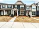 Townhouse featuring a well-maintained front lawn and appealing architectural design at 1108 Township Pkwy, Belmont, NC 28012