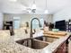 Modern kitchen island with granite countertop and stainless steel sink and faucet at 1108 Township Pkwy, Belmont, NC 28012