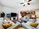 Open-concept living room featuring stylish seating, a ceiling fan and an adjacent kitchen at 1108 Township Pkwy, Belmont, NC 28012