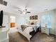 Bright main bedroom featuring a ceiling fan, soft carpet and an ensuite bath at 1108 Township Pkwy, Belmont, NC 28012